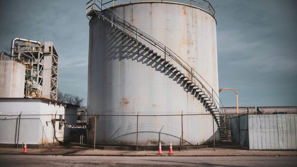 FRP storage tank in industrial facility with external staircase